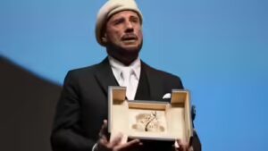 John Travolta tears up over honorary Palme d’Or at Cannes Film Festival; makes directorial debut with ‘Propeller One-Way Night Coach’