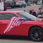 Anti-ICE protester waving upside-down US flag hit by car in New Jersey, video shows her being thrown to the ground
