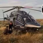 Australian father and son were stranded in the outback for 12 hours after a storm trapped their car; billionaire Tim Roberts, who happened to be flying his helicopter, rescued them
